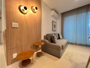 a living room with a couch and a table at LK Savassi 7 in Belo Horizonte