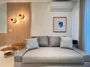 a living room with a couch in a room at LK Savassi 7 in Belo Horizonte +39 photos