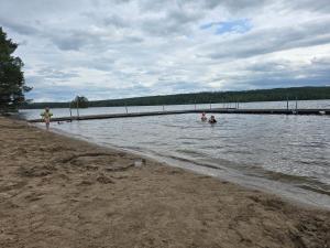 a group of people swimming in a body of water at Edsken Camping in Hofors +2 photos