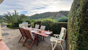 a wooden table and chairs on a patio at Gemütliche Auszeit in Burg