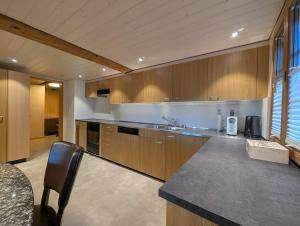 a kitchen with wooden cabinets and a counter top at Rustikale Wohnung auf dem Bauernhof in Malters