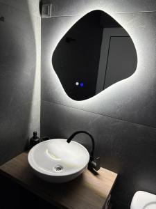 a bathroom with a sink and a mirror at Atelier SkyLine in Gabrovo