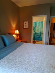 a bedroom with a large bed and a window at 203 at Water's Edge in Ucluelet