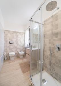a bathroom with a glass shower and a toilet at Pantaleo Rooms in Santadi