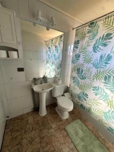 a bathroom with a toilet and a sink at Cabañas Kuela in Puerto Varas +32 photos