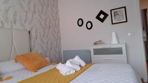 a bedroom with two beds with towels on them at Piso La Cumbre - CEE in Cee