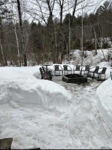 a group of chairs sitting in the snow at Spa - Waterfront - La Source in Saint Come