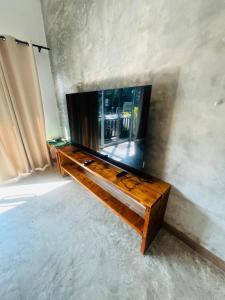 a living room with a television on a table at Modern Elephant Lagoon Villa in Ko Chang +22 photos