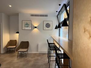 a bar with chairs and a counter in a room at Urban Cube Hostel Granada in Granada