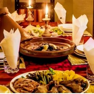 a table topped with plates of food on a table at Magic Luxury Camp in Merzouga +96 photos