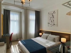 a hotel room with a large bed and a desk at Pera Standard Rooms in Istanbul