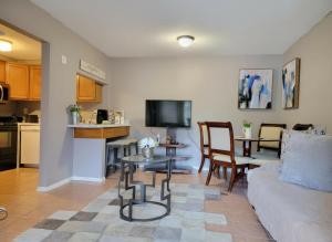 a living room with a couch and a table at Comfy 1BR Apartment - Ideal for Traveling Nurses & Professionals in Gainesville