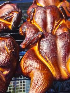 a group of chickens cooking on a grill at Brīvdienu mājas Lejnieki in Strante +27 photos