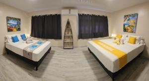 two beds in a room with a room with a ladder at Raiatea Sunrise villa in Taputapuapea +12 photos