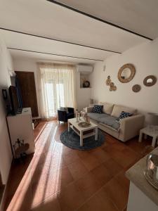 a living room with a couch and a table at Il Tempio Del Gufo in Casoli