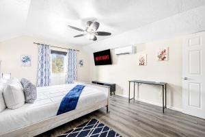 a bedroom with a bed and a ceiling fan at Cozy 2BR - Beach & Trail - Bikes, Fire Pit in St. Petersburg