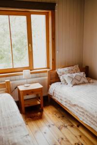 a bedroom with two beds and a window at Viesu nams Smēdes in Limbaži +116 photos