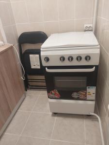 a stove sitting in a corner of a kitchen at Studio Relax2 in Bacău +7 photos