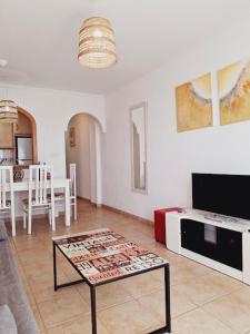 a living room with a couch and a table at Altos del Mar in Santa Pola