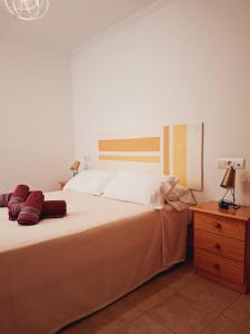 a bedroom with a large bed and a wooden dresser at Altos del Mar in Santa Pola