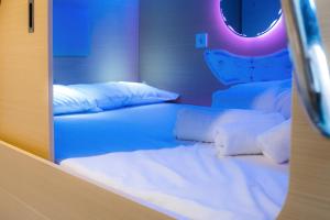 a bed in a room with a mirror at Urban Cube Hostel Granada in Granada +37 photos