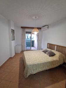 a bedroom with a bed and a chandelier at Sol y Mar Fuengirola in Fuengirola +33 photos