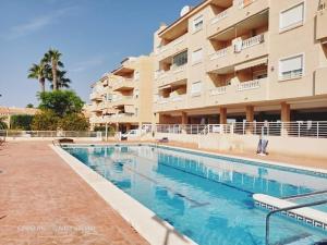 a swimming pool in front of a building at Altos del Mar in Santa Pola