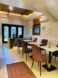 a restaurant with tables and chairs and a counter at Pera Standard Rooms in Istanbul