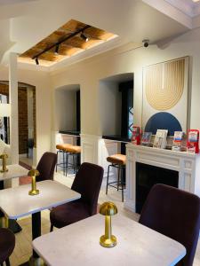 a restaurant with tables and chairs and a fireplace at Pera Standard Rooms in Istanbul