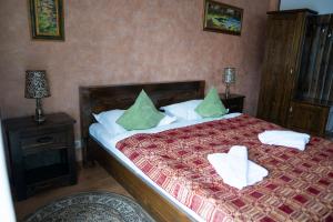 a bedroom with a bed with two towels on it at Hanul Simonului in Bran