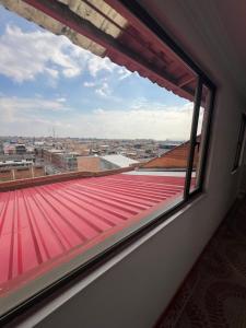 a window with a view of a roof at Hotel El paraiso Funza in Funza