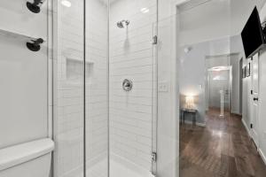 a bathroom with a shower with a glass door at Mint Julep - Studio in Downtown Lexington in Lexington