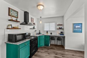 a kitchen with green cabinets and a stove top oven at Mint Julep - Studio in Downtown Lexington in Lexington +14 photos