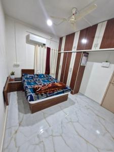a bedroom with a bed in the middle of a room at Laximi Niwas in Nashik
