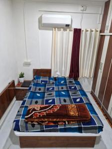 two beds in a room with blue and white at Laximi Niwas in Nashik