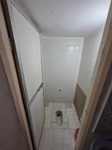 a small bathroom with a toilet in the floor at Laximi Niwas in Nashik