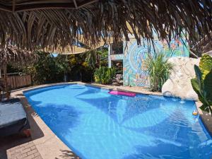 a large blue swimming pool in a resort at La Posada - Hostel in Santa Teresa Beach +48 photos
