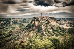 a castle on top of a mountain with trees at Luce su Civita in Lubriano