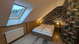 a attic bedroom with a bed and a window at FitnessFun in Krzyż +67 photos