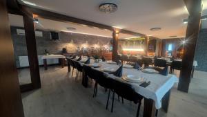 a dining room with a long table and chairs at FitnessFun in Krzyż