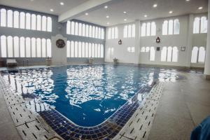 a large swimming pool in a large building at Hotel & Spa Hacienda Baruk in Zacatecas