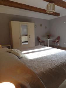 a bedroom with a bed and a table and chairs at Casale Santa Margherita in Bucine +40 photos