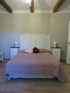 a bedroom with a large bed and two night stands at Casale Santa Margherita in Bucine