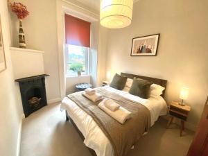a bedroom with a bed with two towels on it at Ochil View in Stirling