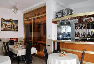 a restaurant with two tables and a bar at Gran Mansion Dorada in Tacna