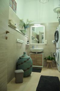 a bathroom with a sink and a toilet and a mirror at La Casetta di Gio' con Parcheggio in Lerici +37 photos