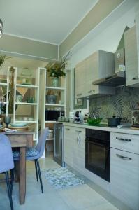 a kitchen with a table and a stove top oven at La Casetta di Gio' con Parcheggio in Lerici
