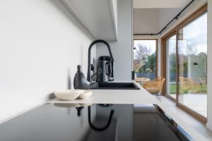 a kitchen with a sink and a counter top at Miło in Lubiatowo +123 photos