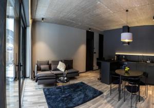 a living room with a couch and a table at JASNÁ Luxury Apartments with Mountain View in Belá +59 photos