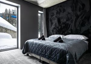 a bedroom with a bed with a large painting on the wall at JASNÁ Luxury Apartments with Mountain View in Belá